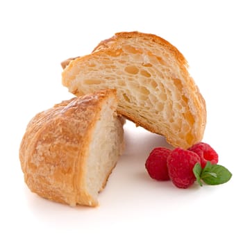 Fresh croissant and raspberries on white background