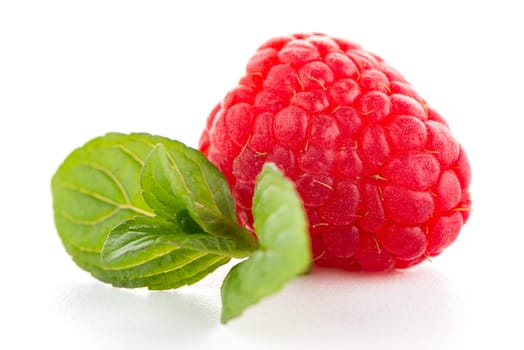 Ripe raspberry with leaf isolated on white background.