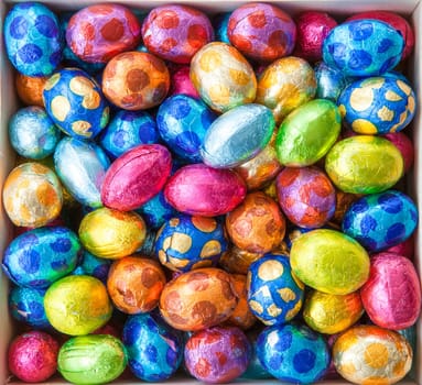 Colorful eggs made of chocolate as a background for Easter