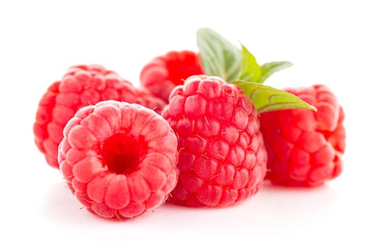 Raspberries with leaves isolated on white background