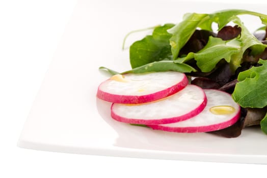 Salad mix with rucola, frisee, radicchio and lamb's lettuce. Isolated on white background.