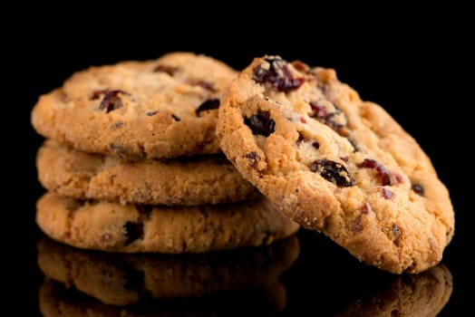 Dried fruits chip cookies isolated on black background.