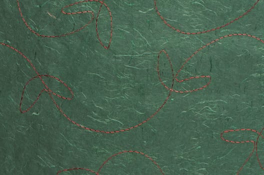 Closeup detail of stitched green recycled paper.