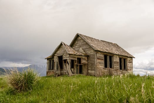 Old abandoned farm in Wyoming, United States. Spring with cloudy sky.