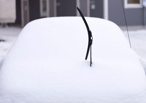 Windscreen Wiper on Snowy Car in winter time.