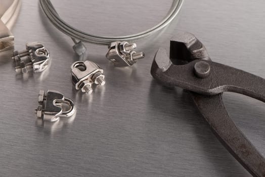 Tool and wires on metal finish background.