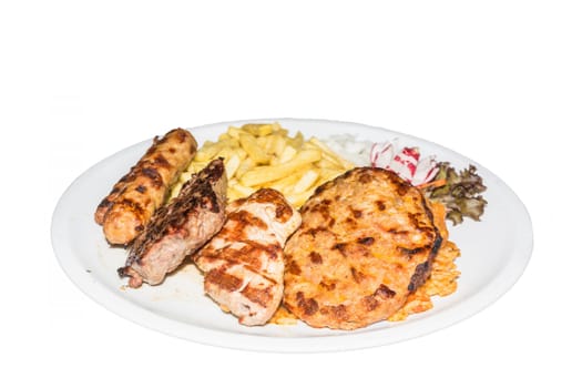 Typical Greek grill plate,with different meats,salad and fries..