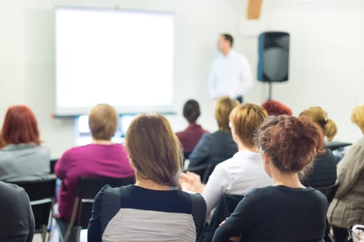 Speaker at business workshop and presentation. Audience at the conference room.