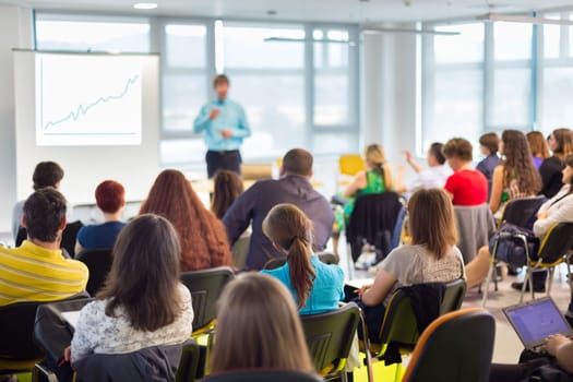 Speaker at business workshop and presentation. Audience at the conference room.