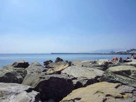 Sunbathing  in Genoa harbor, Italy
