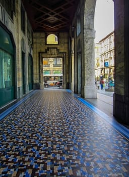 Arcade with mosaic tiles floor in Genoa, Italy