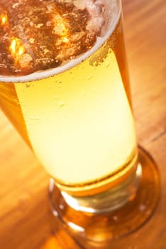 Close-up of a beer glass with foam on the table