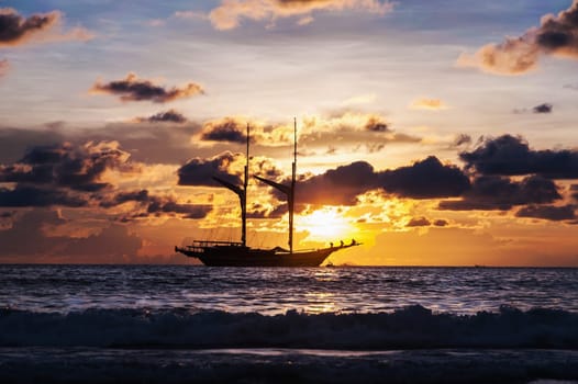 Dramatic sea and transport boat in color of sunset with over dark tone