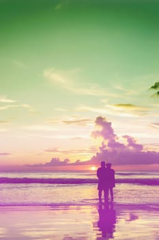 Emotion of love, Lovers relax on the beach in color of sunset vintage tone