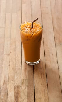 Ice tea with glass on blurred wooden background in dark tone