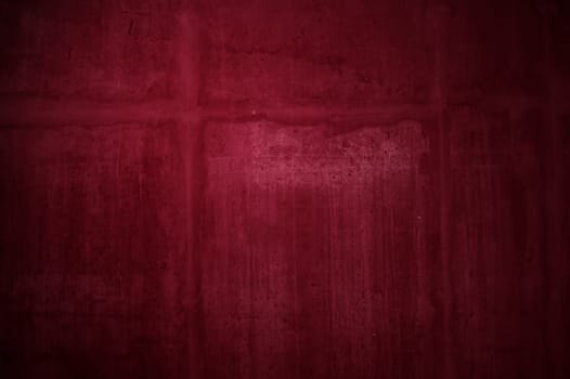 Uneven red stone wall with stains of scratches and dirt