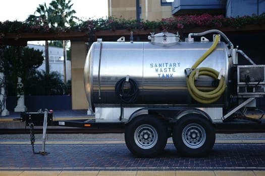 A waste tank for sanitary facilities and toilets is located on the sidewalk of a tram stop.