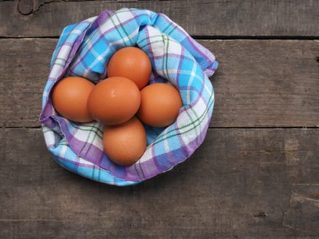 Brown organic eggs on a wooden table