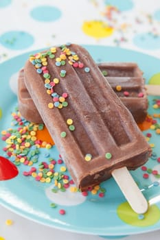 Homemade ice cream on the stem with colorful sugar sprinkles