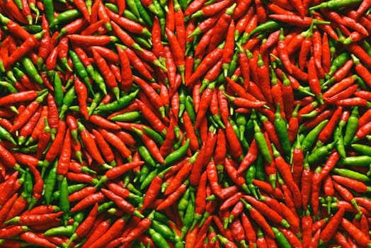 Red and green pepper over flat surface.