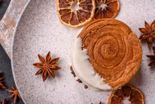 Round sweet New York roll croissant with pistachio cream filling on a dark concrete background