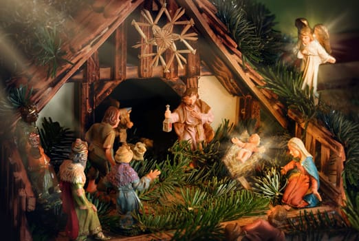 Christ's birth scene with colorful figures and spiritually atmospheric rays of light