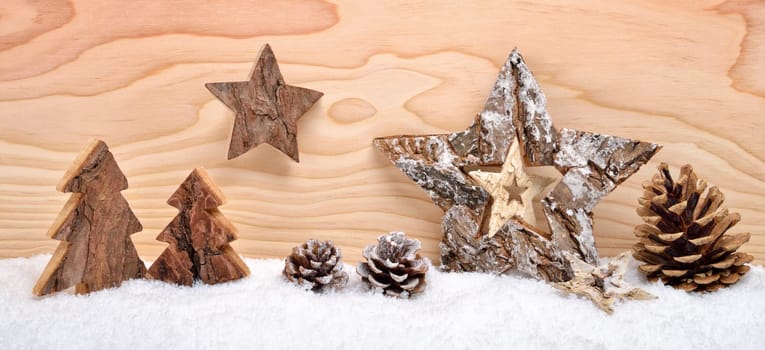 Christmas arrangement of beautiful wooden decoration on snow