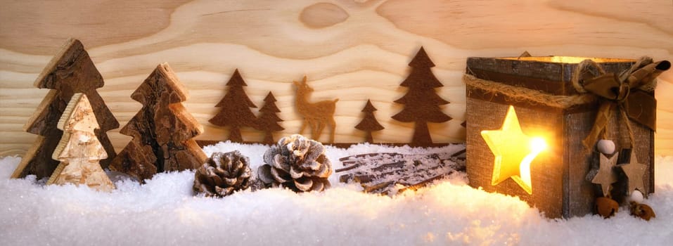 Atmospheric Christmas arrangement of beautiful wooden decoration and lantern on snow