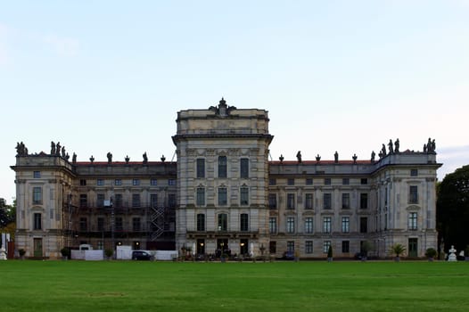 Ludwigslust,Germany – September 23,2014: The rear view of Ludwigslust Castle with a park adjacent lawn and scaffolding on the facade on September 23,2014 in Germany.