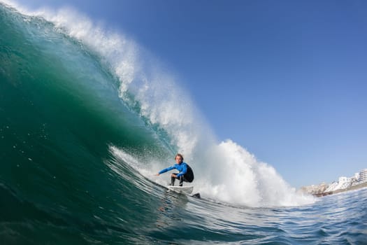 Surfing surfer teenager closeup water action riding hollow ocean wave