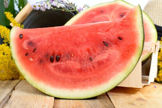 slice of watermelon on a wooden table with flowers