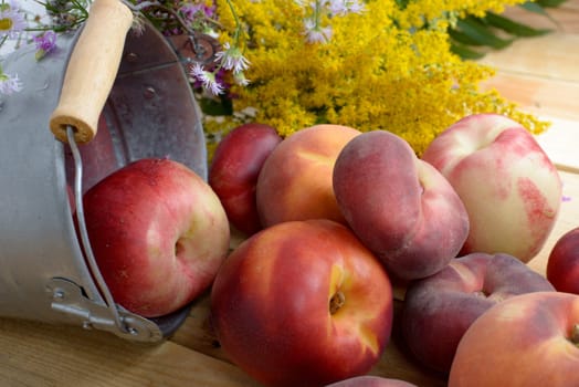 peach and yellow flowers on the wooden table