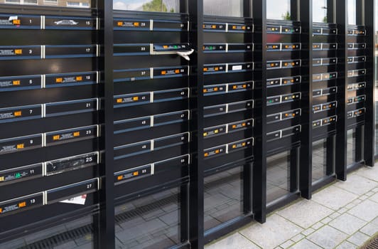 rows of mailboxes in an apartment building