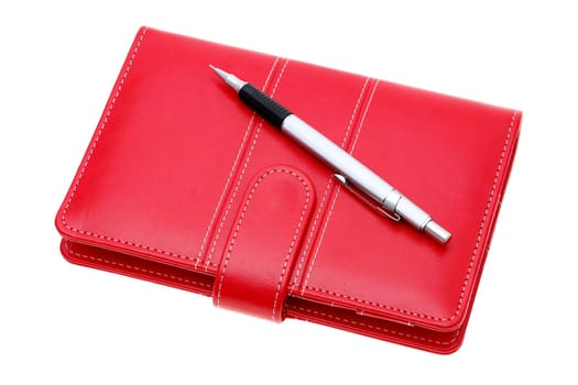 leather notebook and ballpoint pen