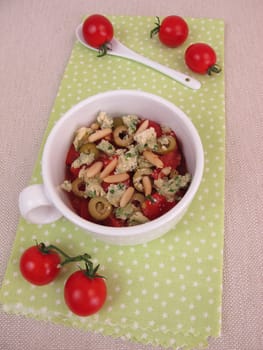Cupscrumble with tomato,olive and cheese crumbles ond pine nuts from the microwave