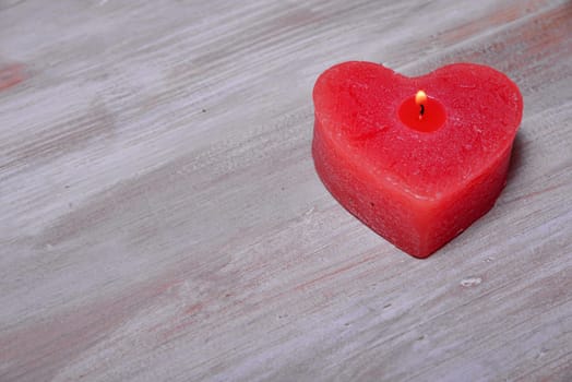 red heart on wood background flame
