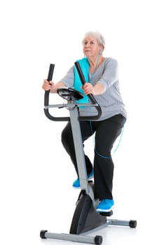 gray-haired female senior train with fitness machine