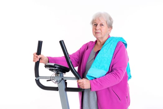 gray-haired female senior train with fitness machine
