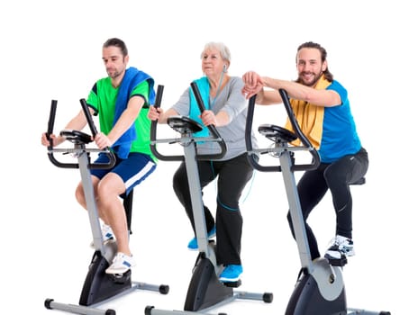 female senior and two young men in fitness center