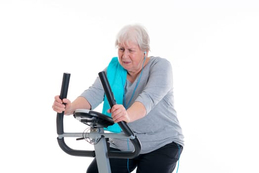 gray-haired female senior train with fitness machine