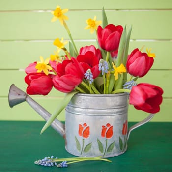 Fresh colorful frugal flowers in vintage tin casting can