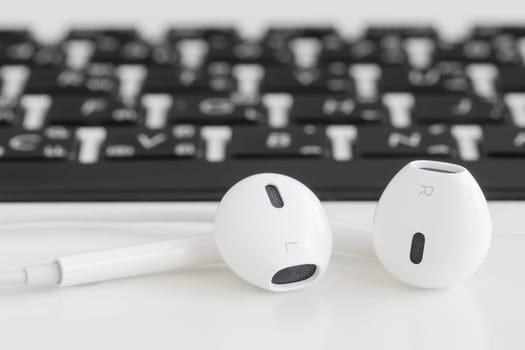 close up earbuds music accessories on laptop computer