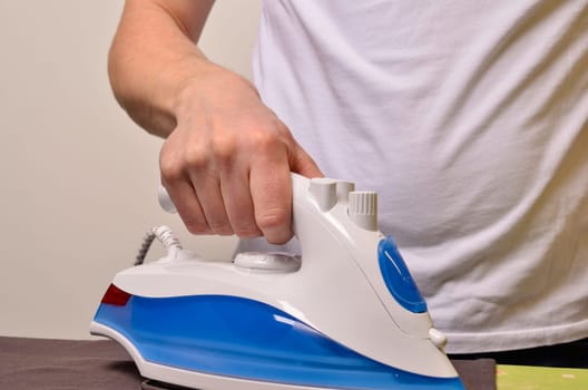 Man ironing his cloth