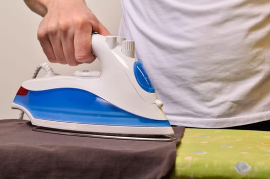 Close up shot of a man ironing his cloth
