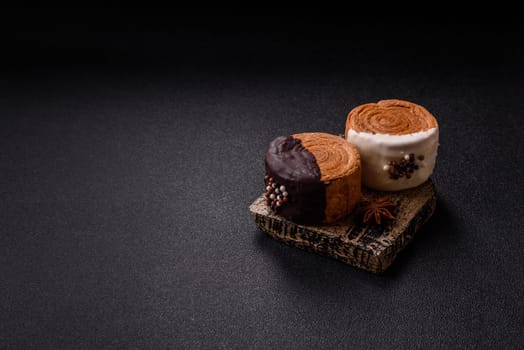Round sweet New York roll croissant with chocolate cream filling on a dark concrete background