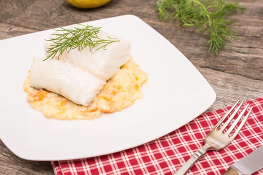 Plate of cod fish and puree with potatoes and carrots
