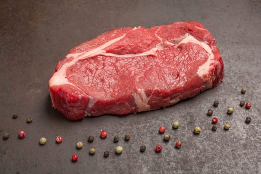 Dry aged steak raw and peppercorns