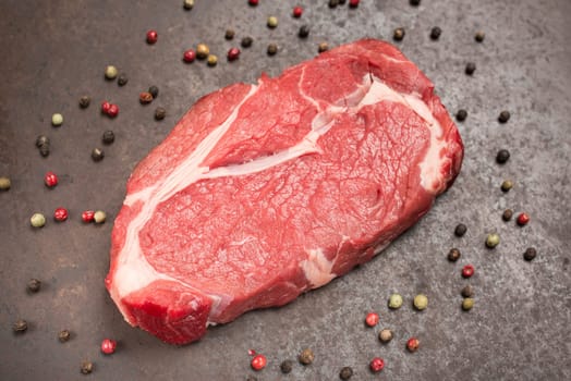 Top view rib eye steak dry aged with peppercorns