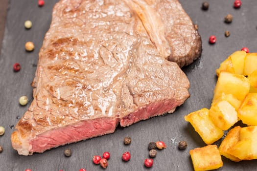 Top view pink fried dry age steak from beef with potatoes