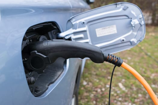 charging electric car with a cord and plug